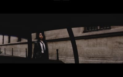 a woman standing in front of a building