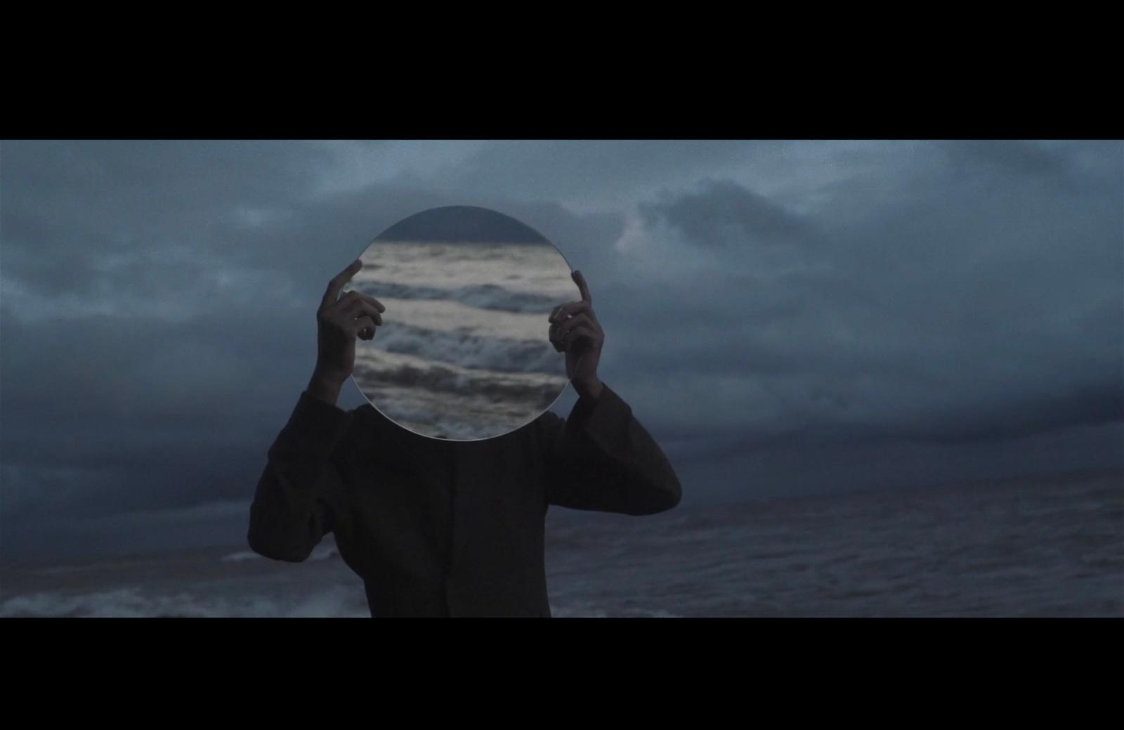 a person holding a mirror up to their face