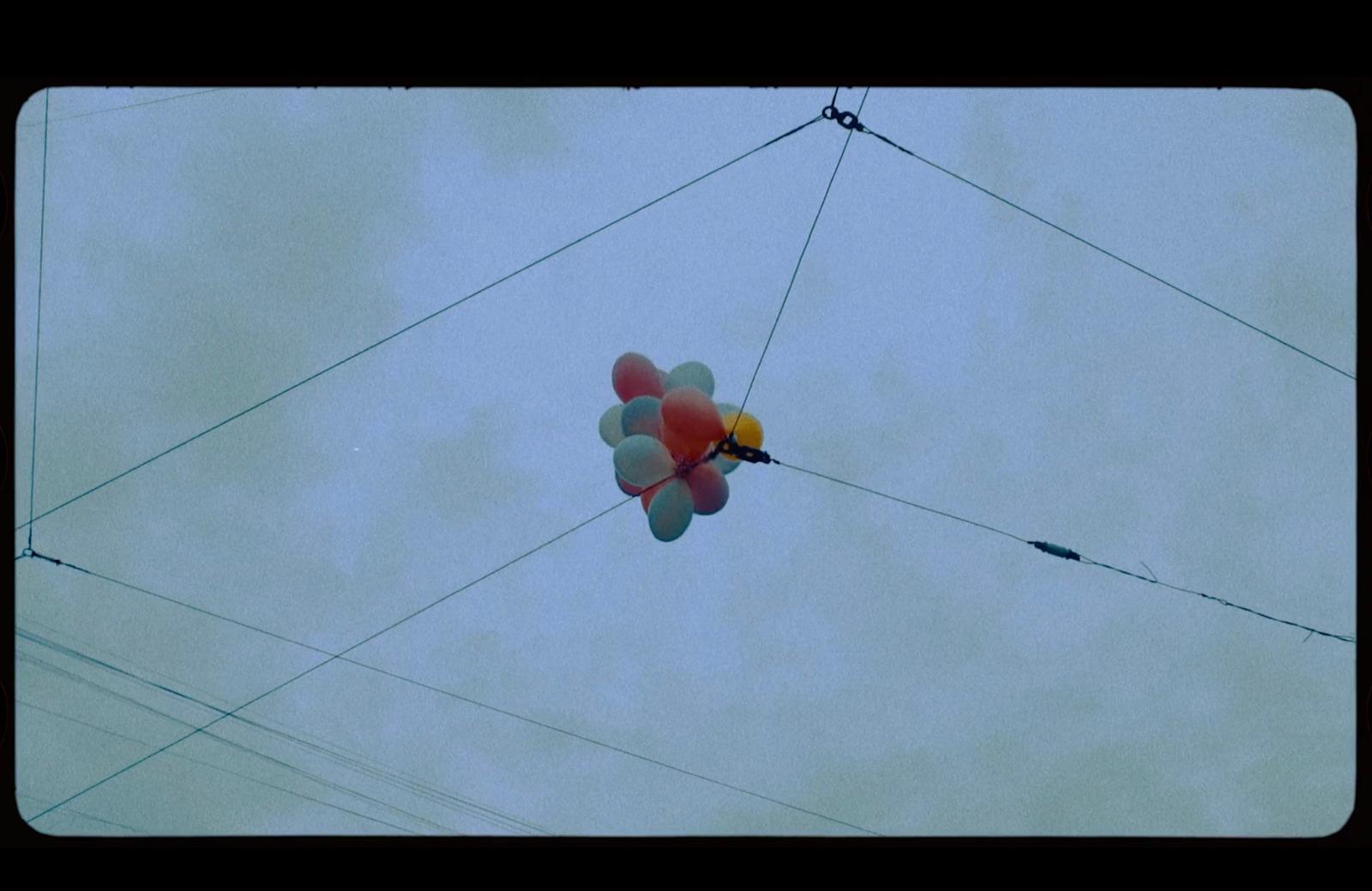 a bunch of balloons that are in the air