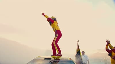 a person on a surfboard on top of a car