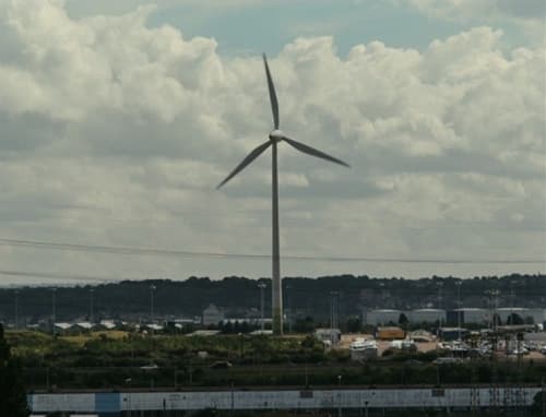 a wind turbine in the middle of a field
