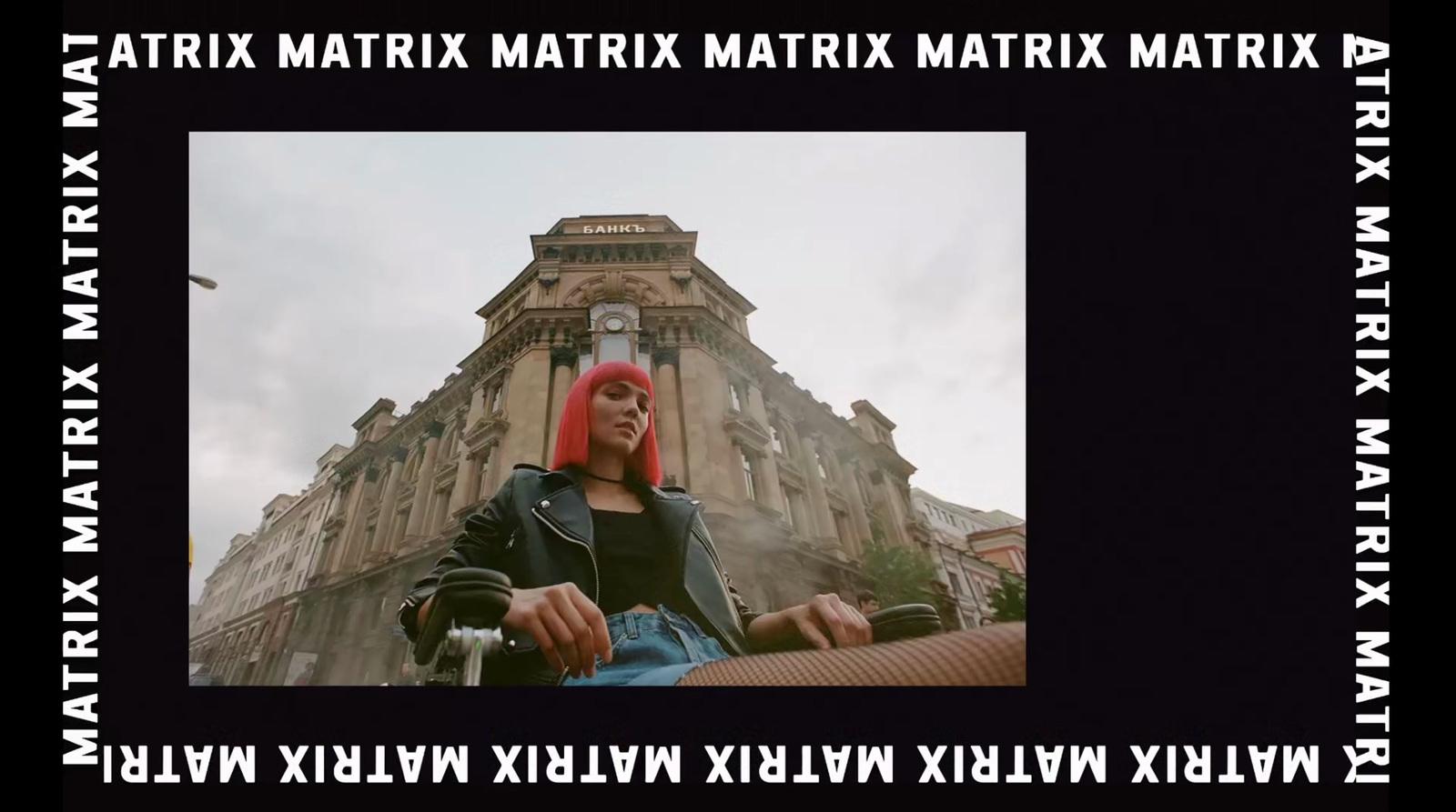 a woman with red hair sitting in front of a building