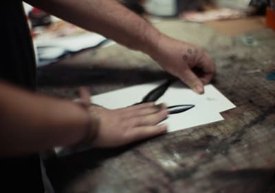 a person cutting paper with a pair of scissors