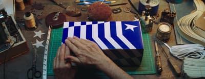 a person working on a blue and white box