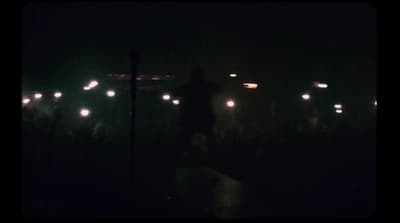 a blurry photo of a person standing in the dark