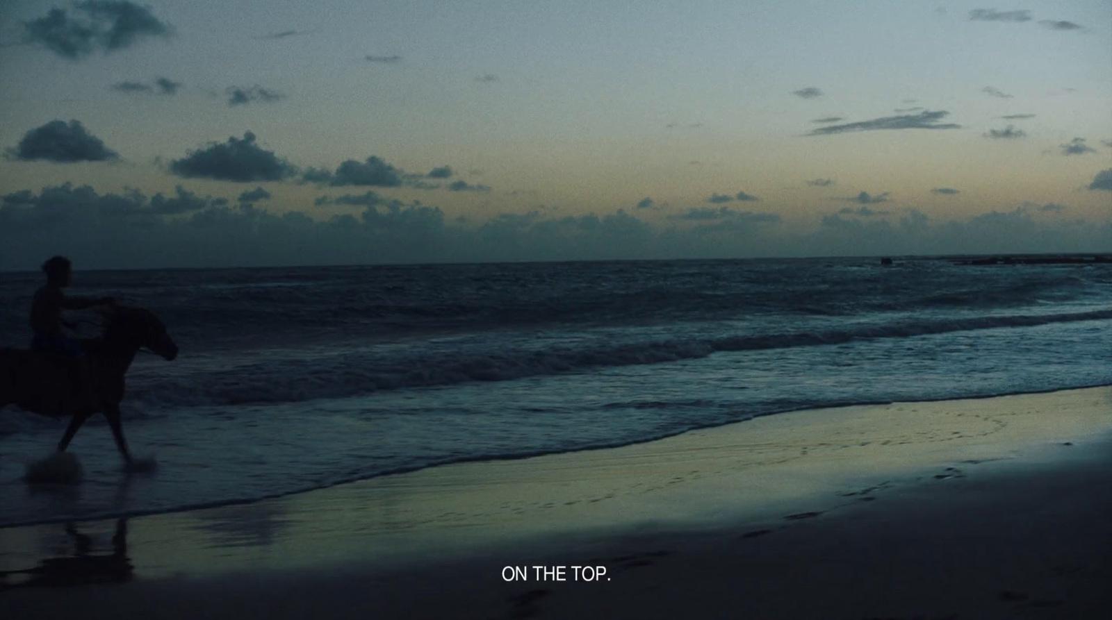 a person riding a horse on the beach