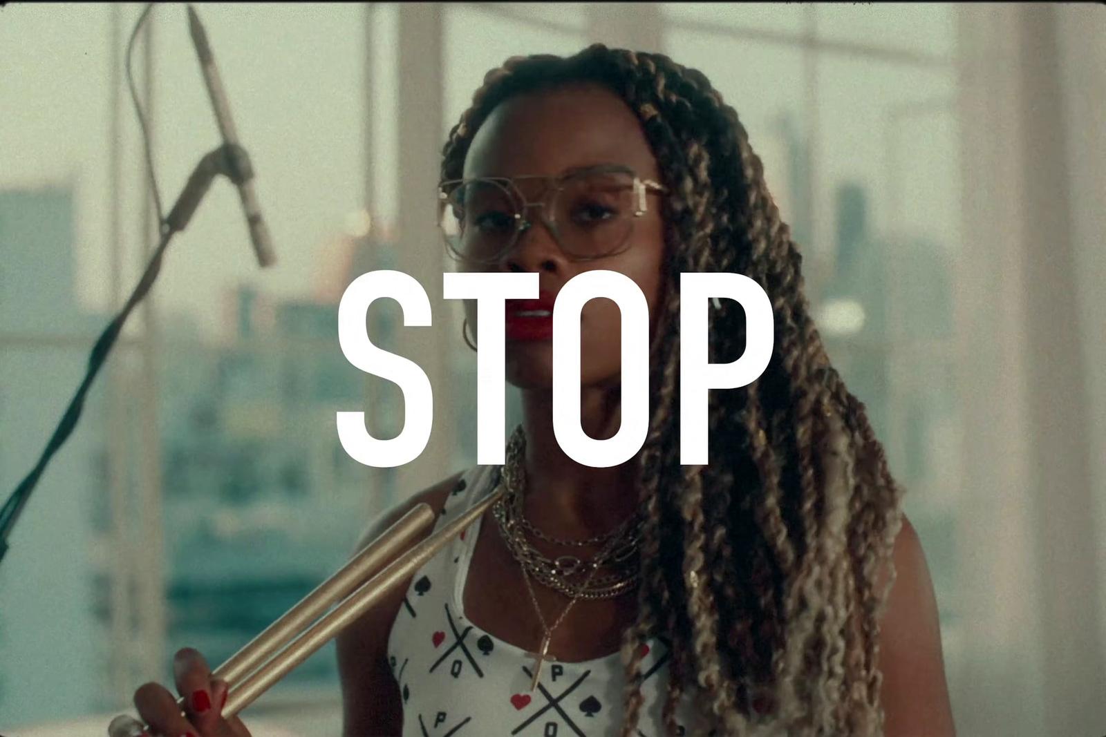 a woman with dreadlocks holding a microphone