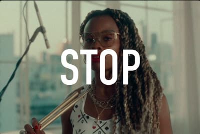 a woman with dreadlocks holding a microphone