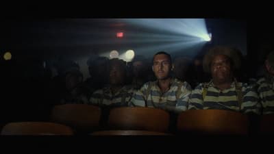 a group of men sitting next to each other in front of a crowd