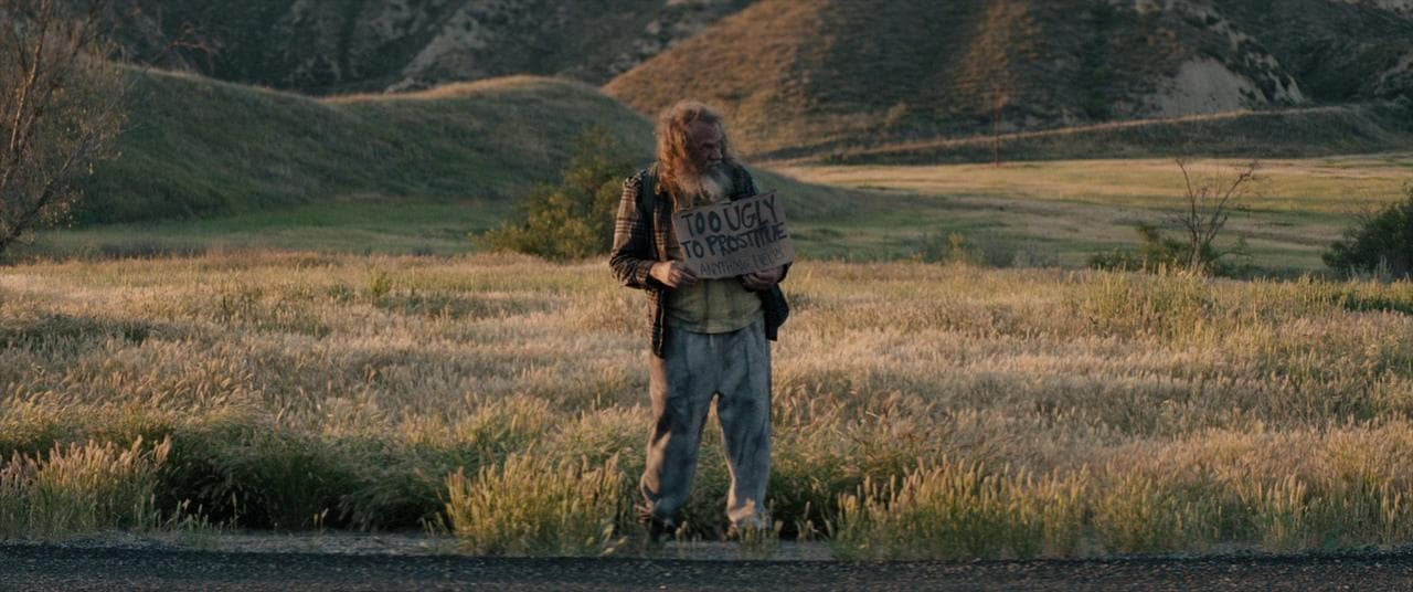 a person standing in a field with a backpack