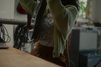 a woman holding a wine glass in her hand
