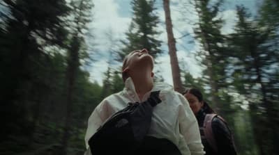 a couple of people that are standing in the woods