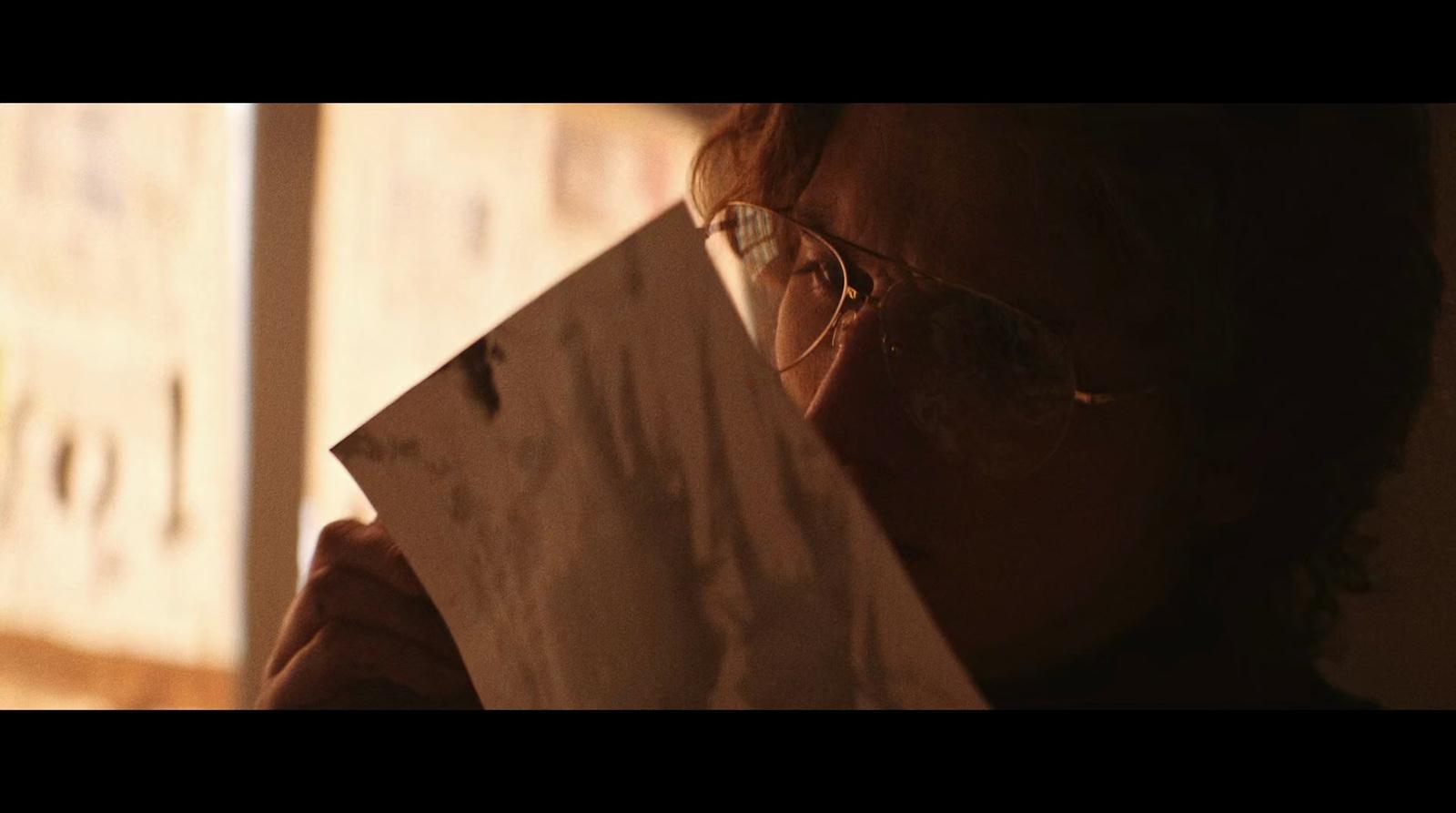 a man holding a piece of paper in his hands