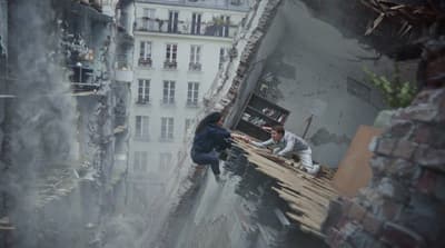 a couple of people standing on top of a building