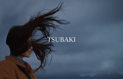 a woman with her hair blowing in the wind