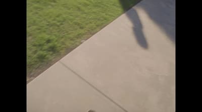 a man riding a skateboard down a cement ramp