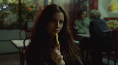 a woman holding a toothbrush in her mouth