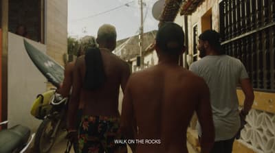a group of men walking down a street next to a motorcycle