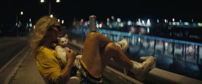 a man sitting on a ledge with a dog
