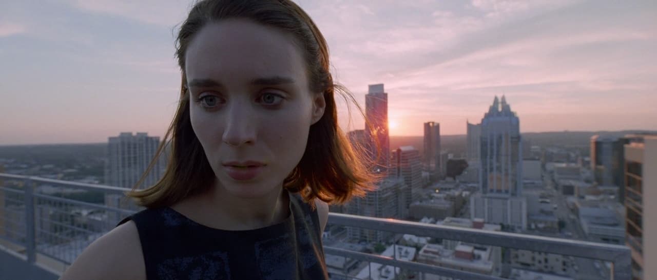a woman standing in front of a city skyline