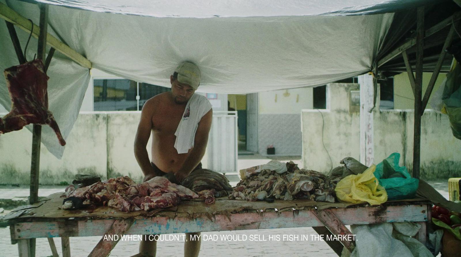 a man standing over a table covered in meat
