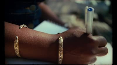 a close up of a person's arm with two bracelets on it