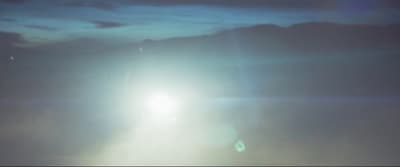 a bright light shines brightly in the dark sky