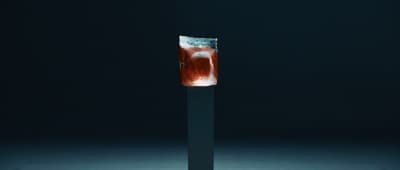 a tall glass with a liquid inside of it