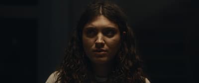 a woman with long hair looking at the camera