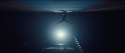 a person walking up a flight of stairs in the dark