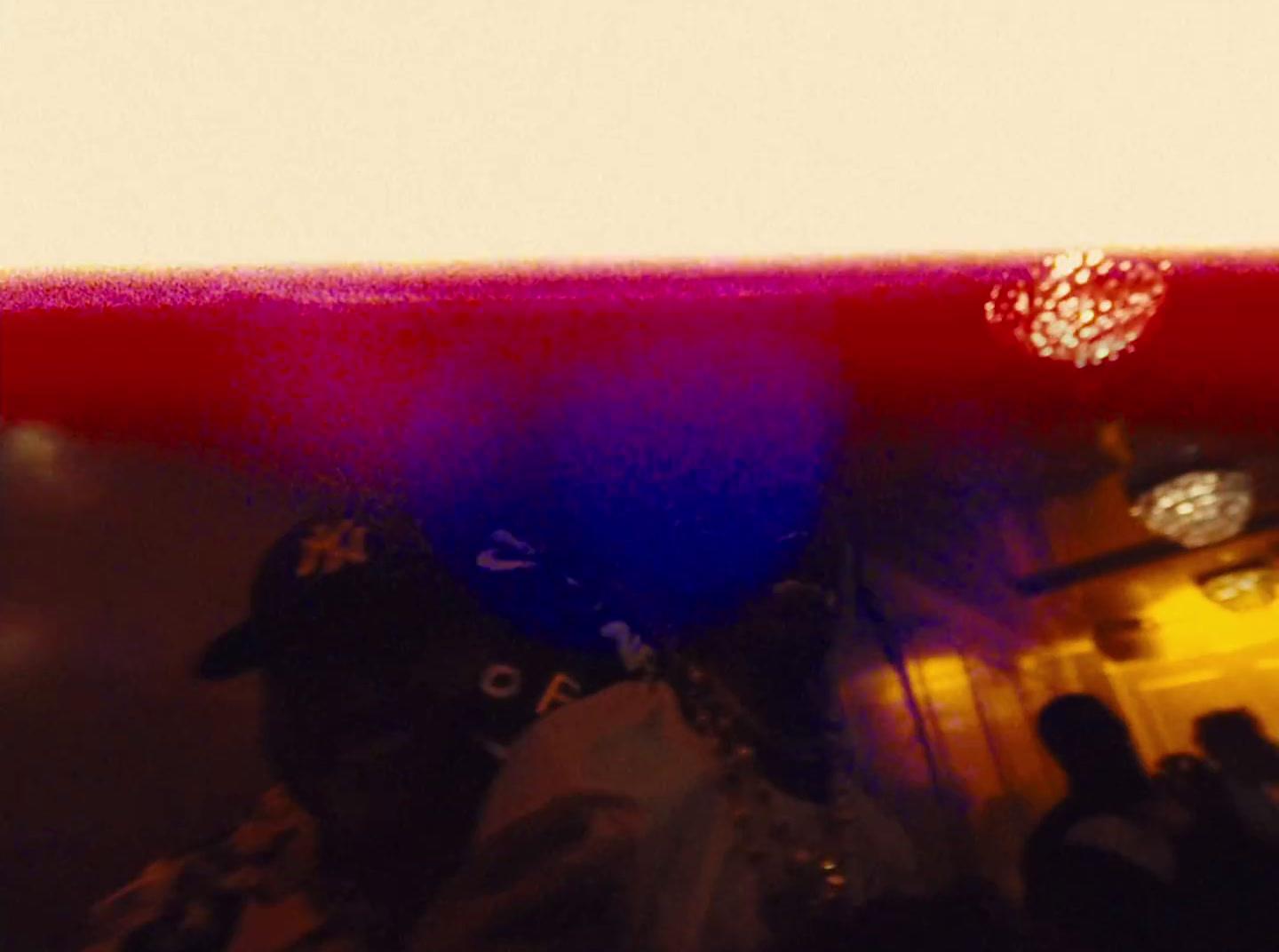 a blurry photo of a person holding a blue and red object