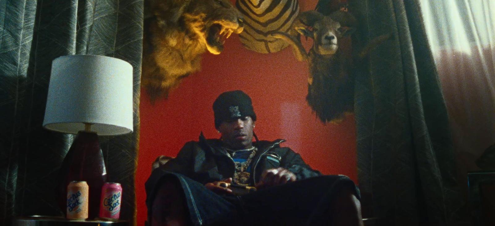 a man sitting in a chair next to a lamp