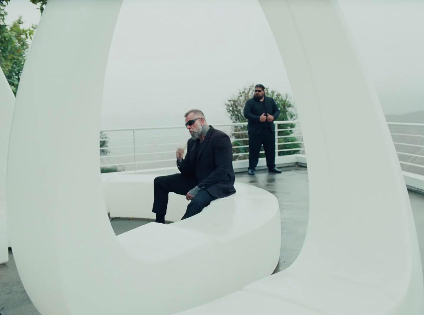 a man sitting on top of a white sculpture