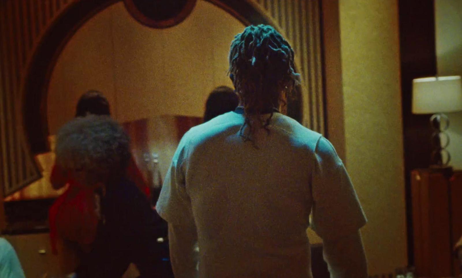 a woman with dreadlocks standing in front of a mirror