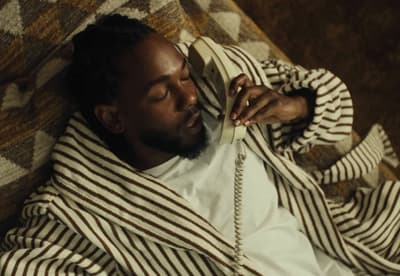 a man laying on a couch talking on a phone