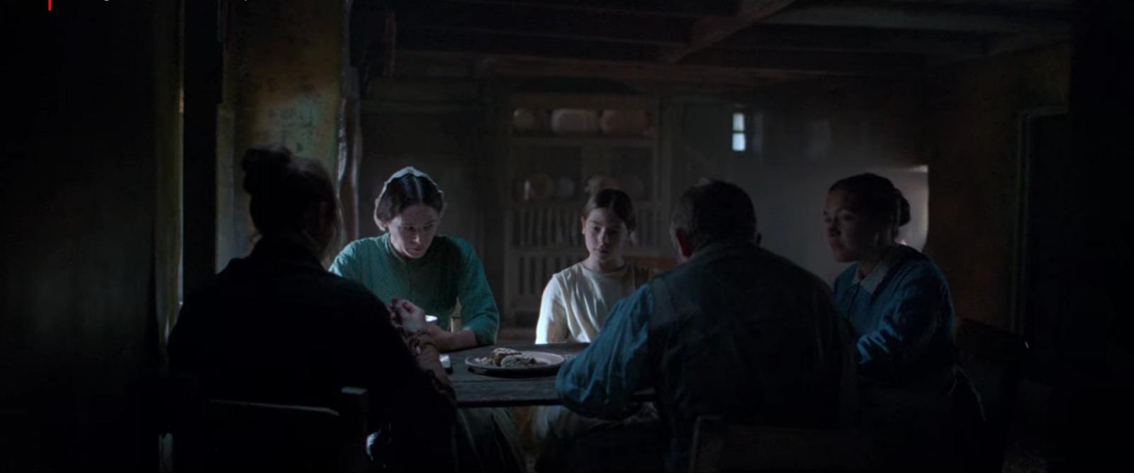 a group of people sitting around a table