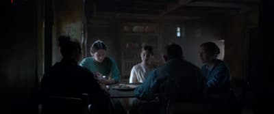 a group of people sitting around a table