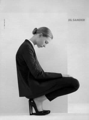 a black and white photo of a woman sitting on a chair