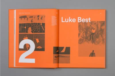 a book opened to a page with a picture of people in the background