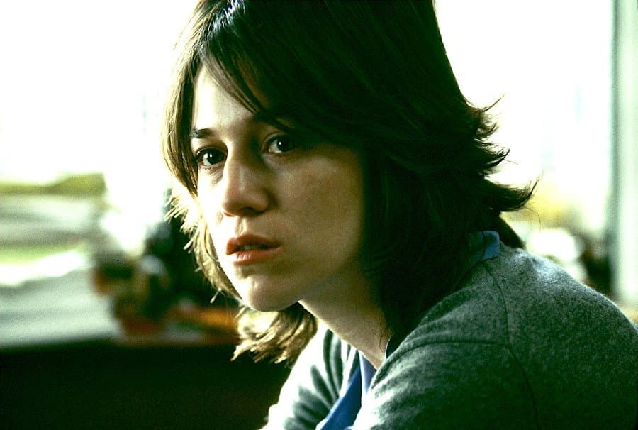 a close up of a person sitting in a room