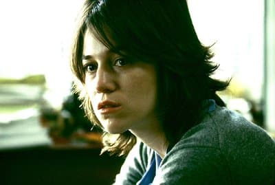 a close up of a person sitting in a room