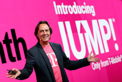 a man standing in front of a pink sign