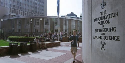 a man walking down a sidewalk next to a building