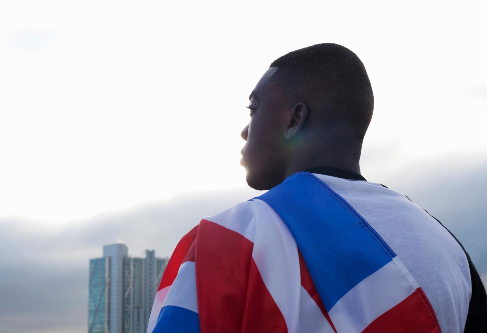 a man with a flag draped around his neck