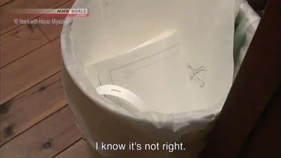 a white bucket with a sticker on it sitting on a wooden floor
