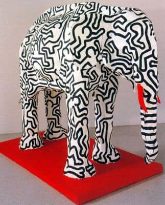 a sculpture of an elephant on a red platform
