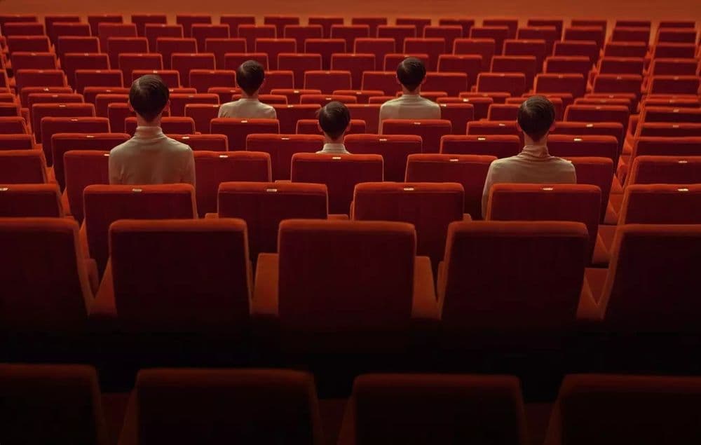 a group of people sitting in a movie theater