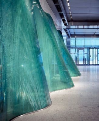 a room with a large green curtain in the middle of it