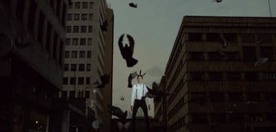 a man standing on top of a tall building