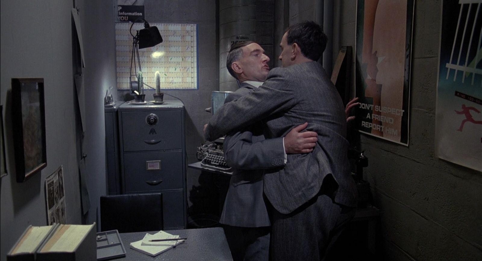 a couple of men hugging each other in a room
